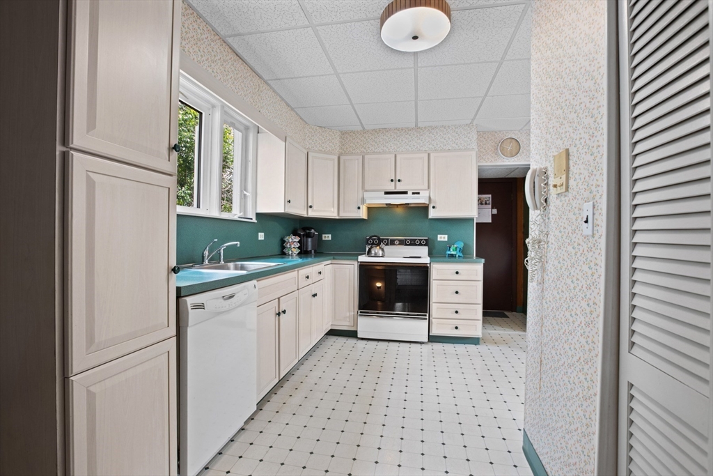 8 A 3rd Street Medford, MA 02155 - Photo 11 of 24 a kitchen with stainless steel appliances a refrigerator sink and cabinets