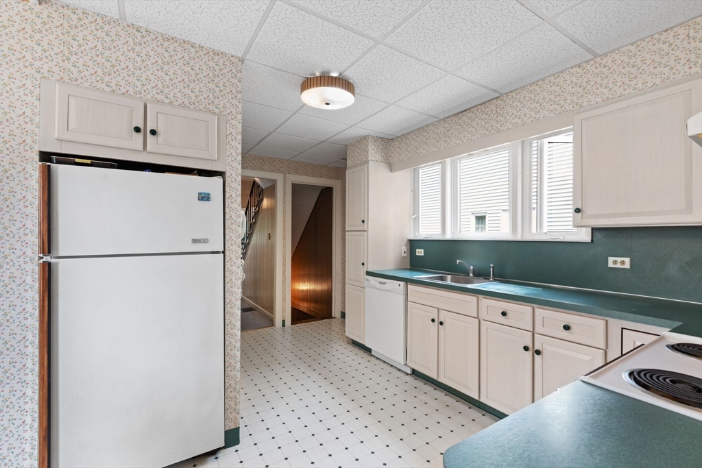 8 A 3rd Street Medford, MA 02155 - Photo 12 of 24 a kitchen with stainless steel appliances a refrigerator sink and cabinets
