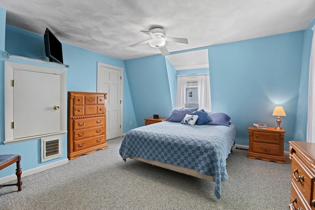 8 A 3rd Street Medford, MA 02155 - Photo 13 of 24 a bedroom with bed and a chandelier
