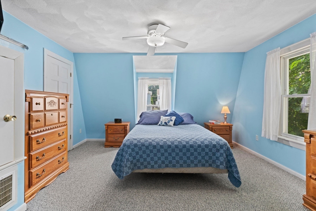 8 A 3rd Street Medford, MA 02155 - Photo 15 of 24 a bedroom with a bed and a chandelier