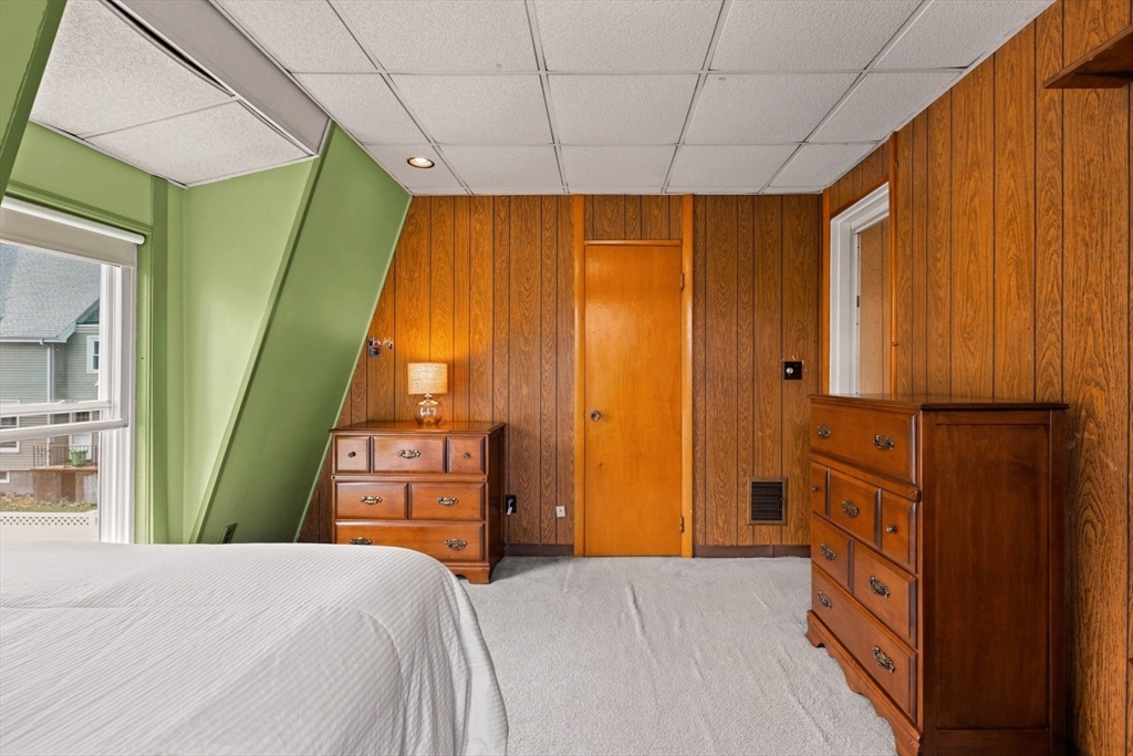 8 A 3rd Street Medford, MA 02155 - Photo 18 of 24 a bedroom with a bed and a window