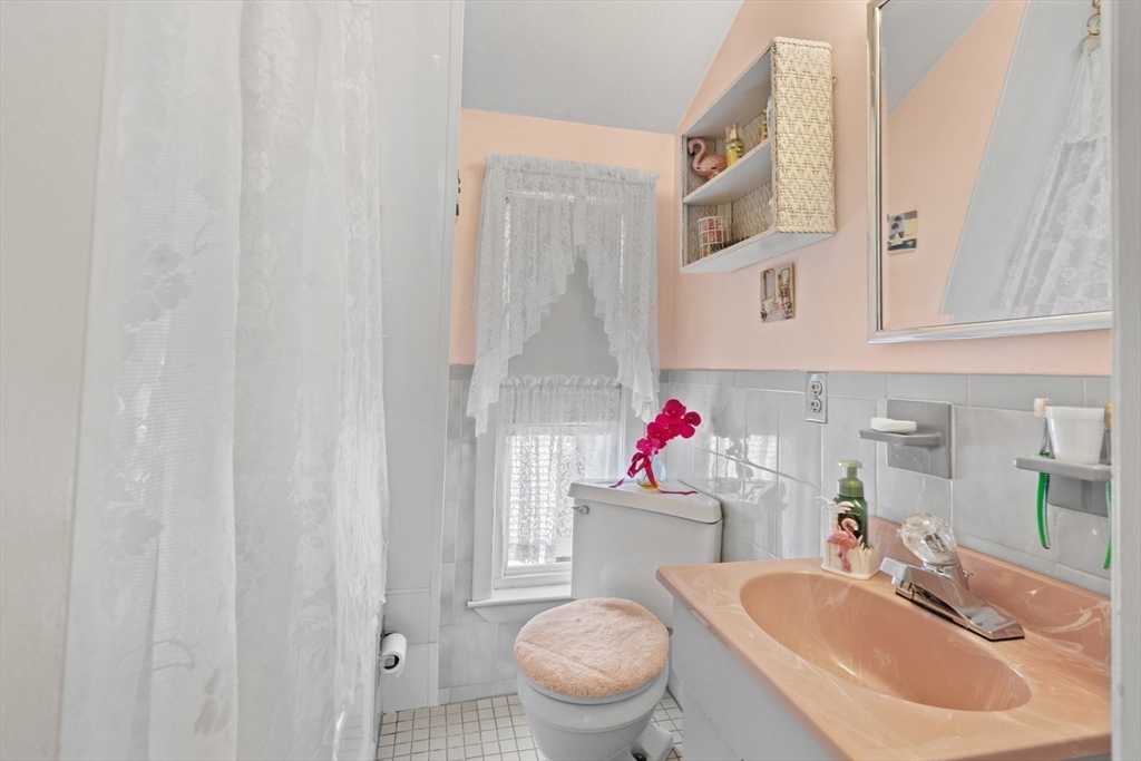 8 A 3rd Street Medford, MA 02155 - Photo 20 of 24 a bathroom with a sink toilet and a mirror
