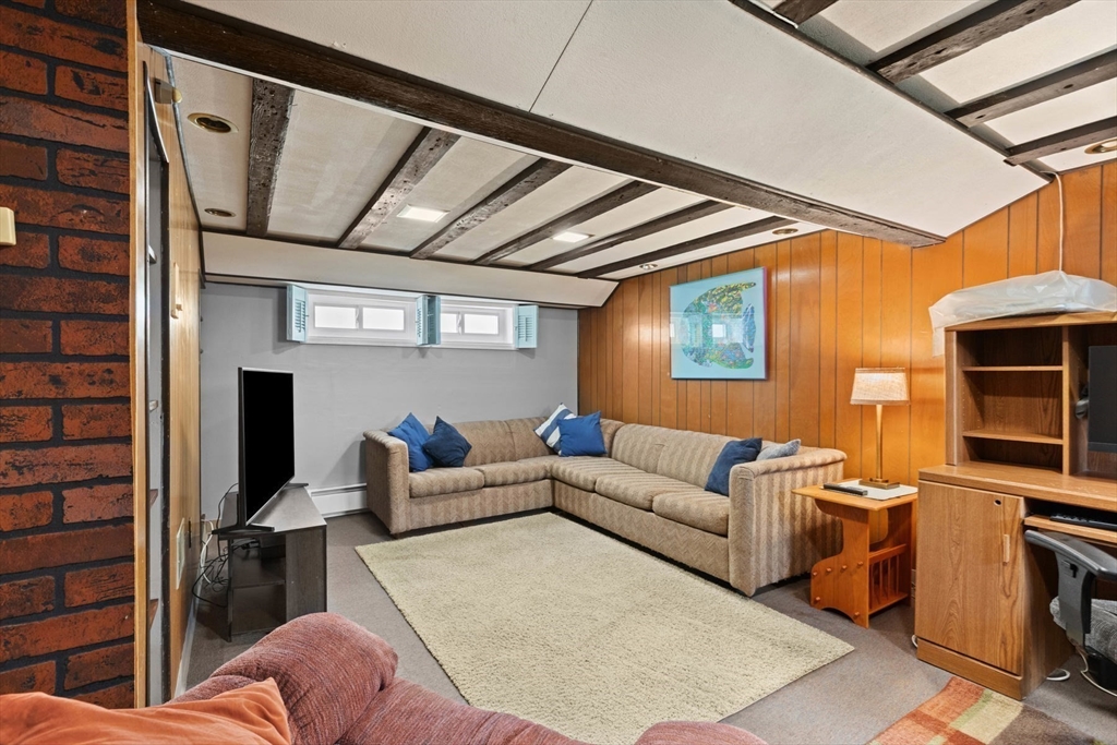 8 A 3rd Street Medford, MA 02155 - Photo 23 of 24 a living room with furniture a fireplace and a flat screen tv