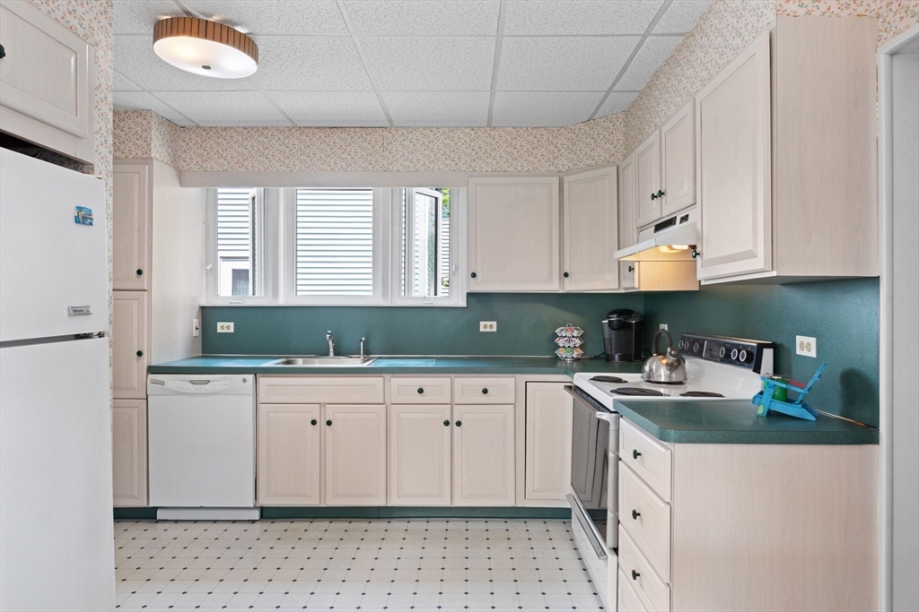 8 A 3rd Street Medford, MA 02155 - Photo 10 of 24 a kitchen with granite countertop white cabinets and a stove