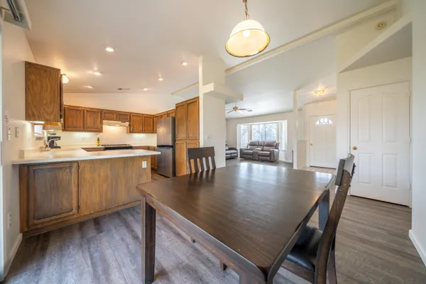 a kitchen with a dining table chairs and microwave