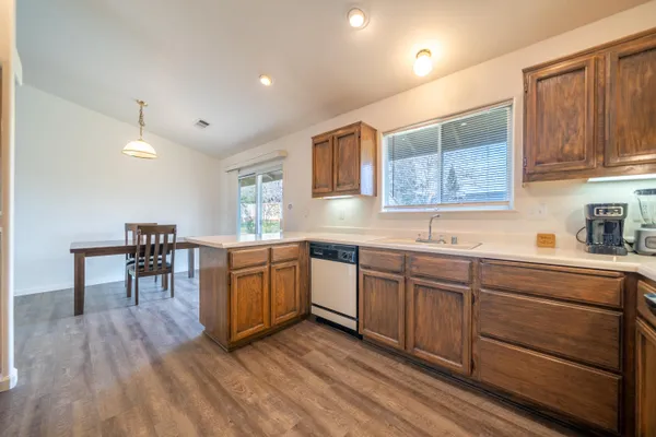 a kitchen with sink cabinets and wooden floor