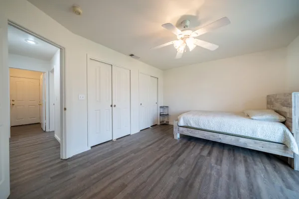 a bedroom with a bed and a ceiling fan