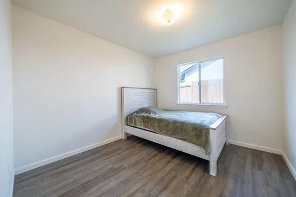 a bedroom with a bed and window