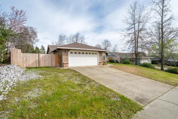 a sign board with yard and fence
