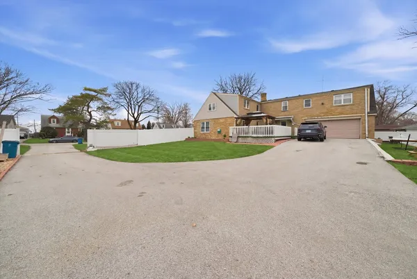 a view of house with outdoor space and parking