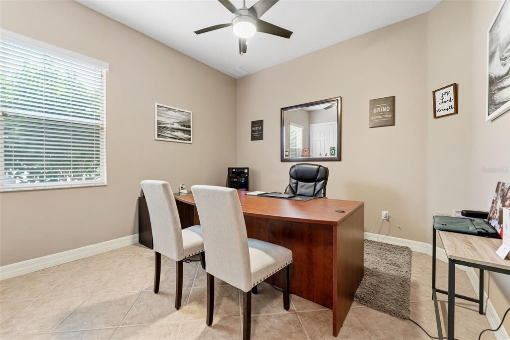 4460 Birchfield Loop Spring Hill, FL 34609 - Photo 16 of 38 a view of a dining room with furniture and wooden floor