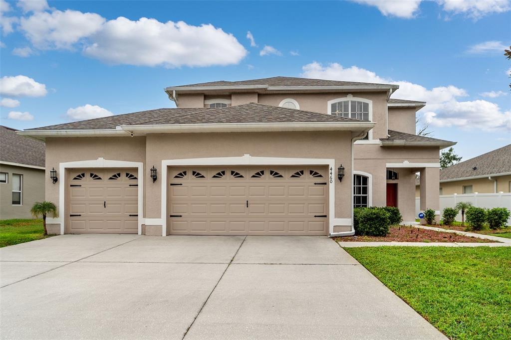 4460 Birchfield Loop Spring Hill, FL 34609 - Photo 3 of 38 a front view of a house with a yard