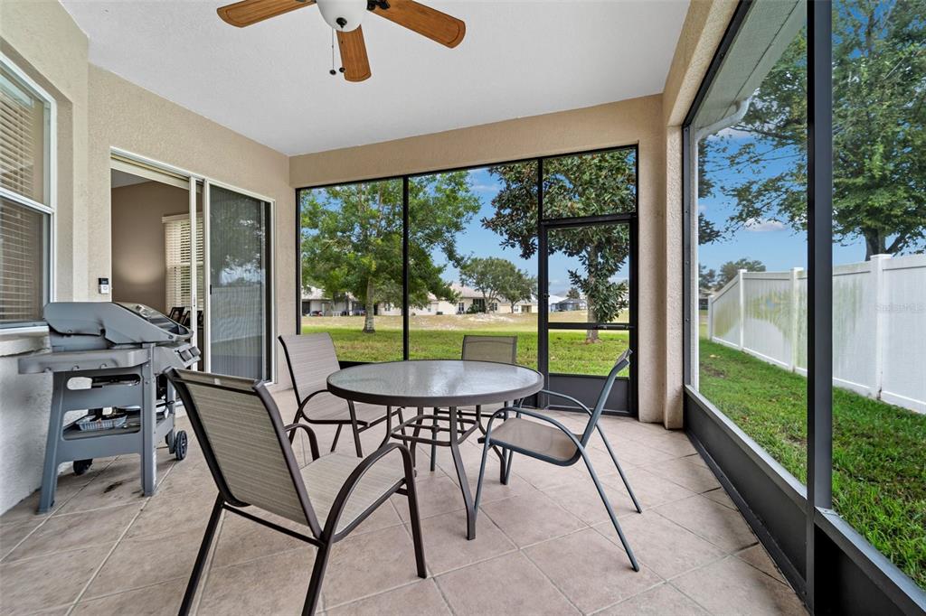 4460 Birchfield Loop Spring Hill, FL 34609 - Photo 34 of 38 a view of a patio with a table chairs and a porch