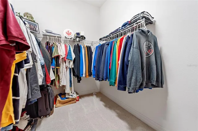 a view of walk in closet with clothes