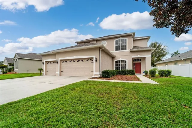a front view of a house with a yard and garage