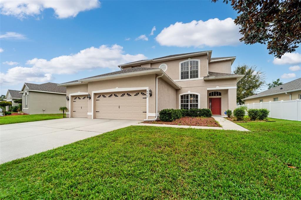 4460 Birchfield Loop Spring Hill, FL 34609 - Photo 5 of 38 a front view of a house with a yard and garage