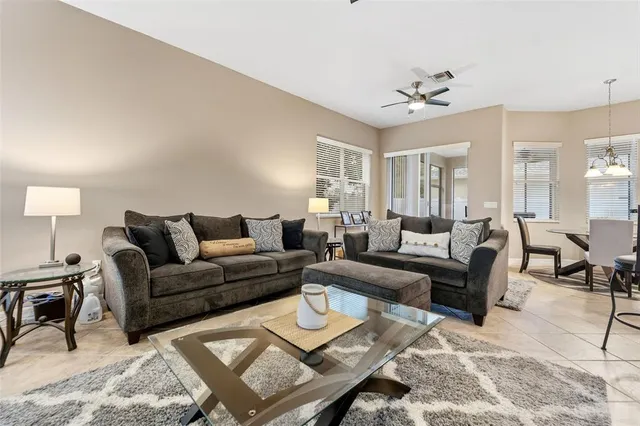 a living room with furniture a rug and a chandelier