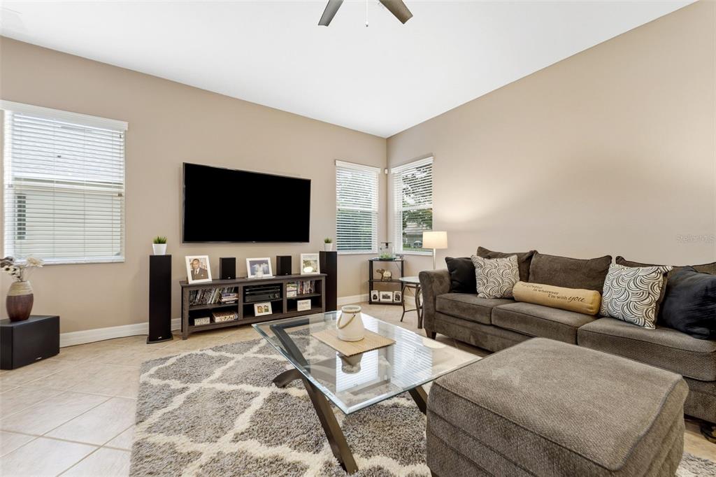 4460 Birchfield Loop Spring Hill, FL 34609 - Photo 10 of 38 a living room with furniture and a flat screen tv