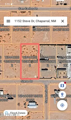 a view of a dry yard with a tree