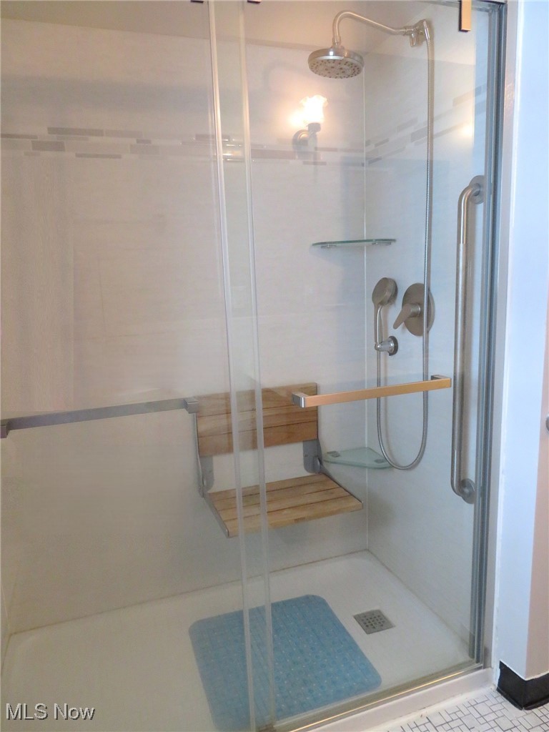 38505 Sugar Ridge Road North Ridgeville, OH 44039 - Photo 22 of 44 The walk-in shower has been updated to accomodate handicap accessability with grab bars & the wooden flip up seat