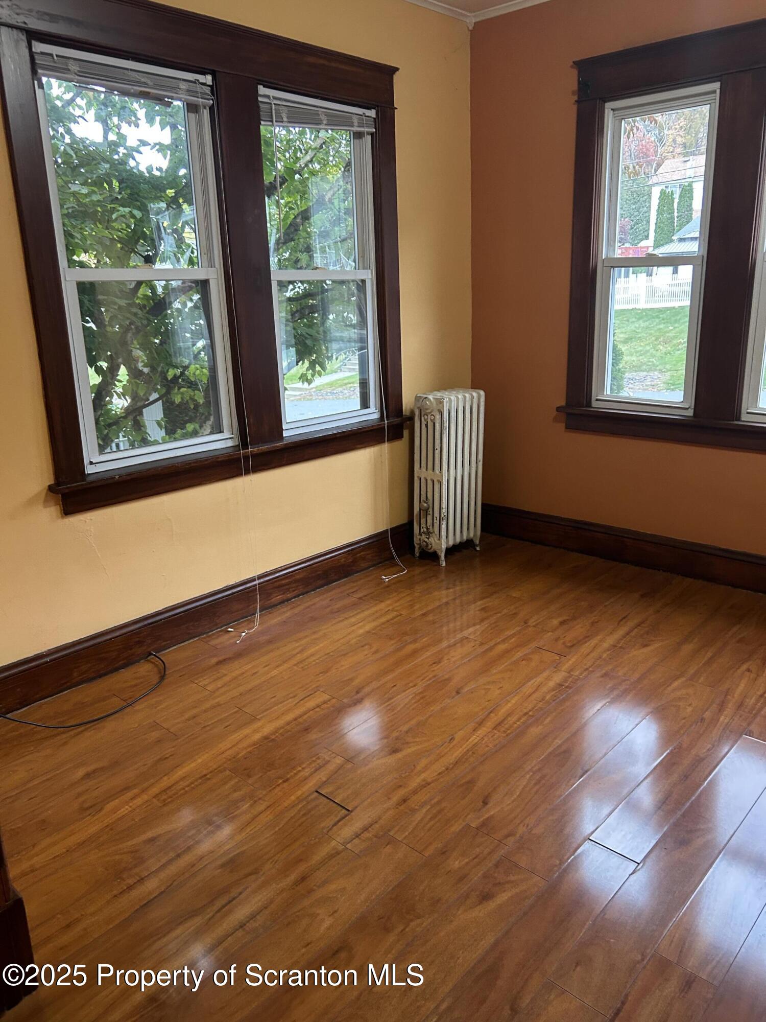 510 Moltke Avenue, Unit FIRST FLOOR #1 Scranton, PA 18505 - Photo 12 of 27 a view of an empty room with wooden floor and a window