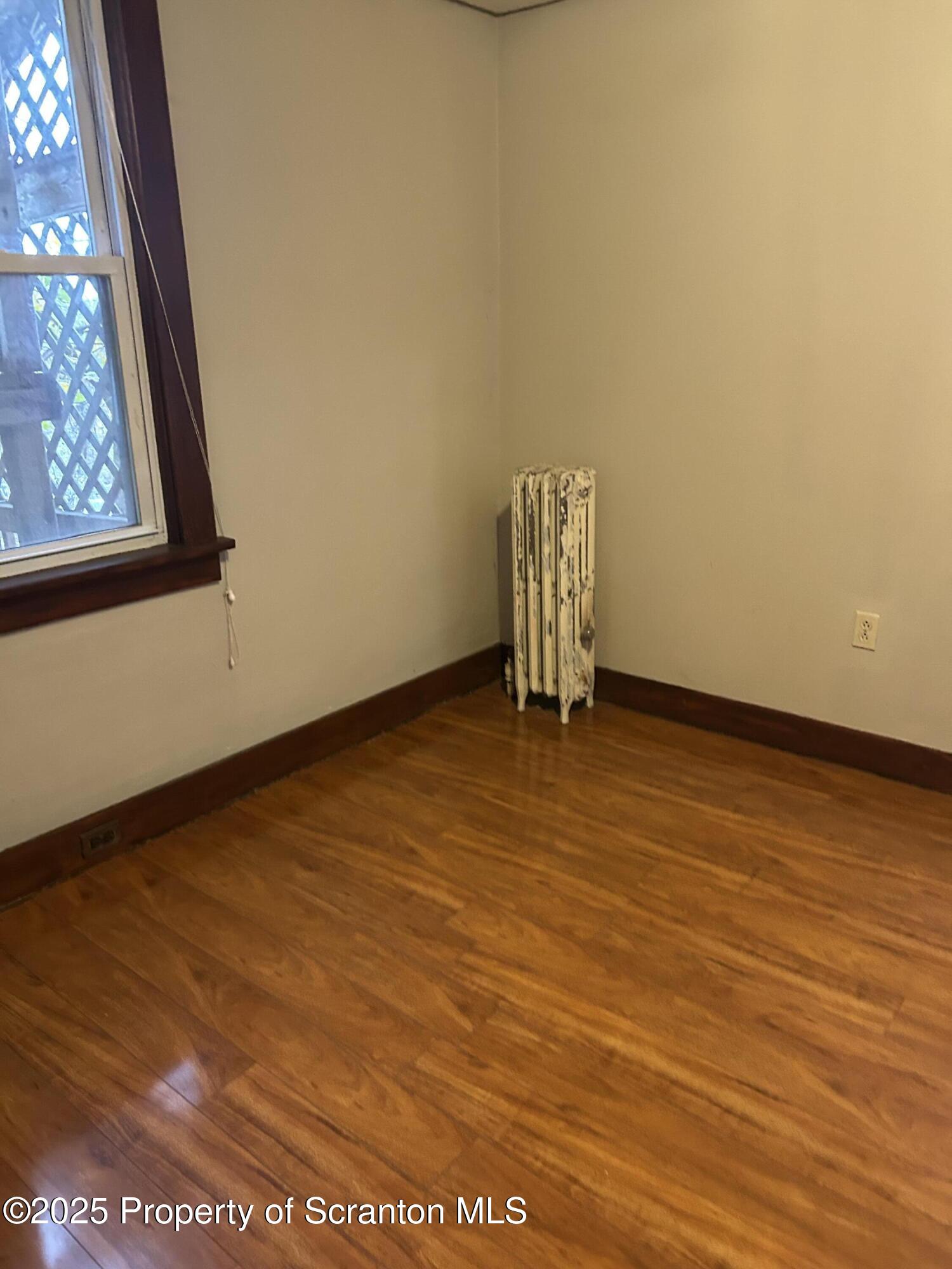 510 Moltke Avenue, Unit FIRST FLOOR #1 Scranton, PA 18505 - Photo 16 of 27 an empty room with wooden floor and windows