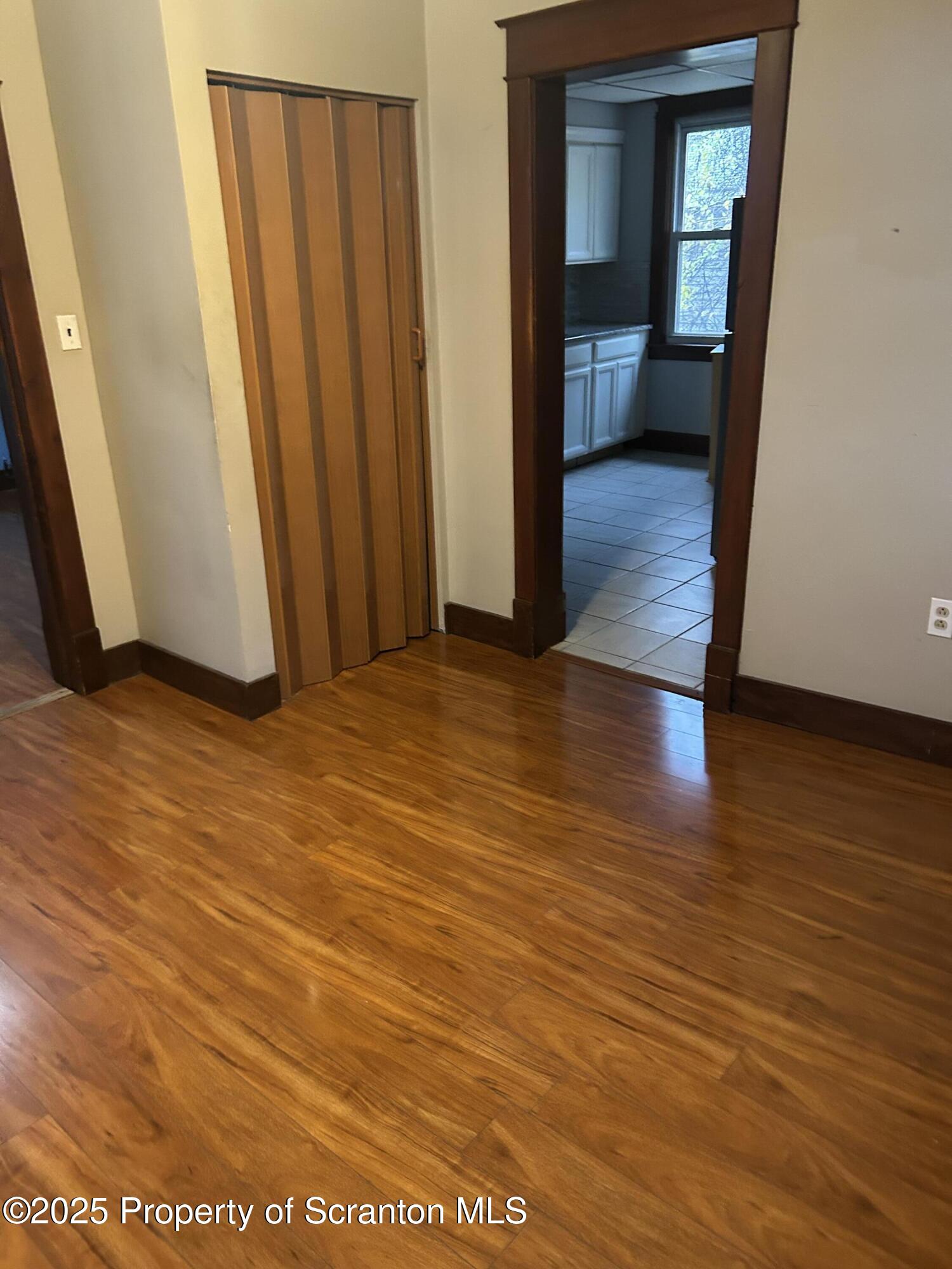 510 Moltke Avenue, Unit FIRST FLOOR #1 Scranton, PA 18505 - Photo 17 of 27 an empty room with wooden floor and a bathroom