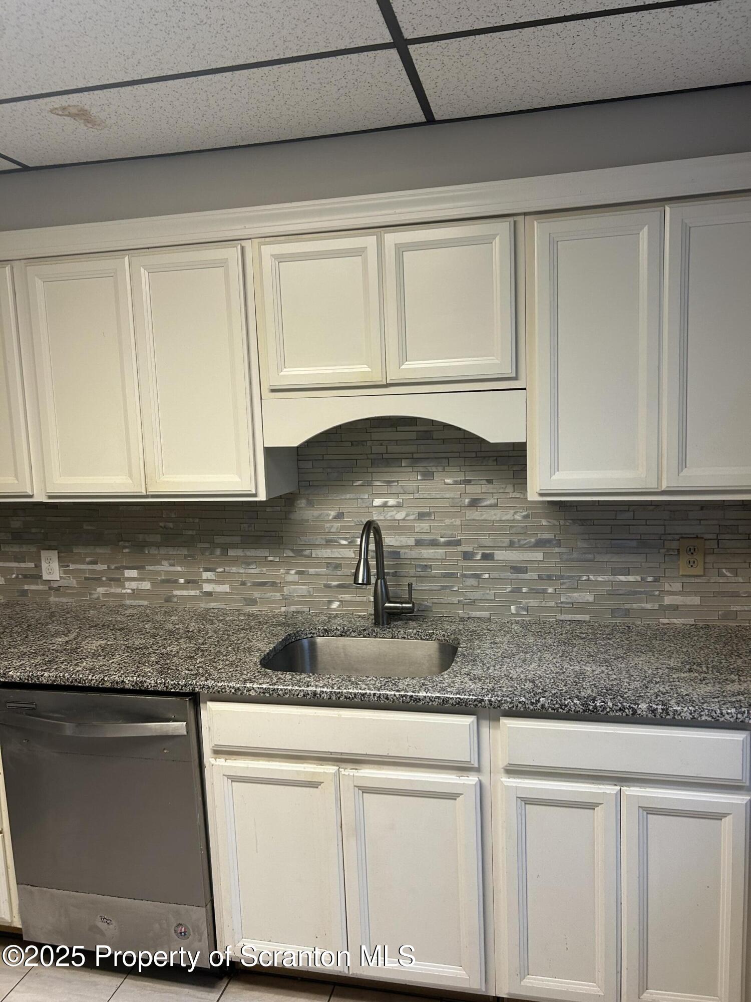 510 Moltke Avenue, Unit FIRST FLOOR #1 Scranton, PA 18505 - Photo 20 of 27 a kitchen with granite countertop a sink a stove and cabinets