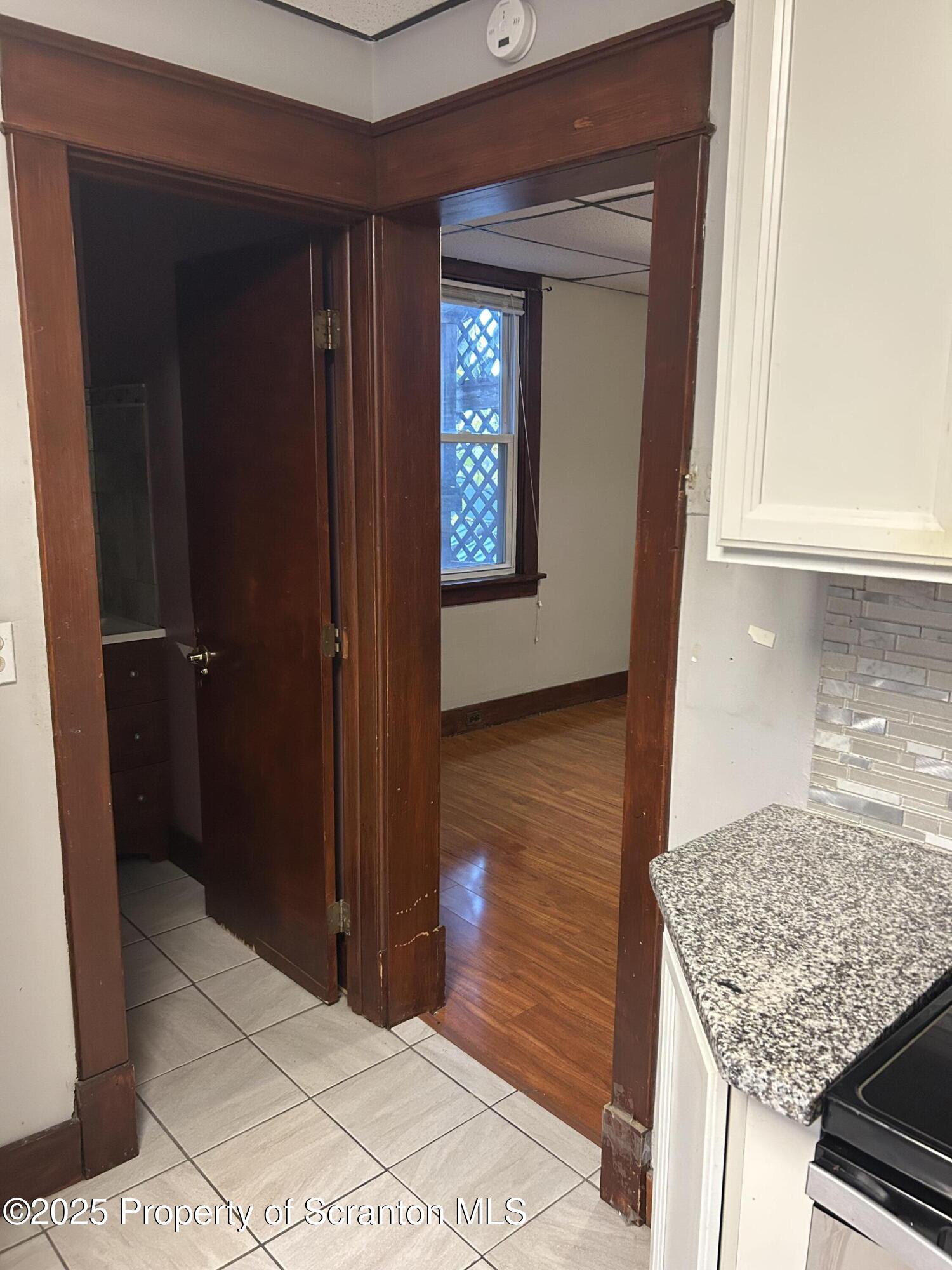 510 Moltke Avenue, Unit FIRST FLOOR #1 Scranton, PA 18505 - Photo 22 of 27 a bathroom with a granite countertop sink and a mirror
