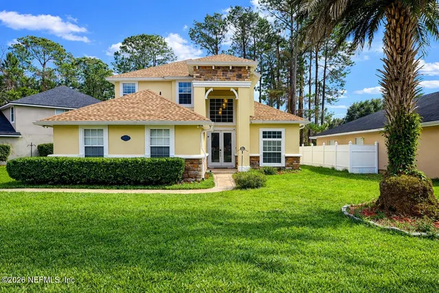 a front view of a house with a yard and garage
