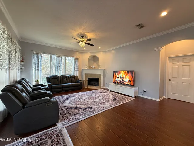 a living room with furniture flat screen tv and a fireplace