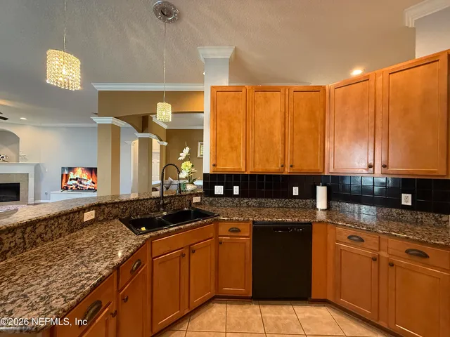 a kitchen with stainless steel appliances granite countertop a sink stove and cabinets