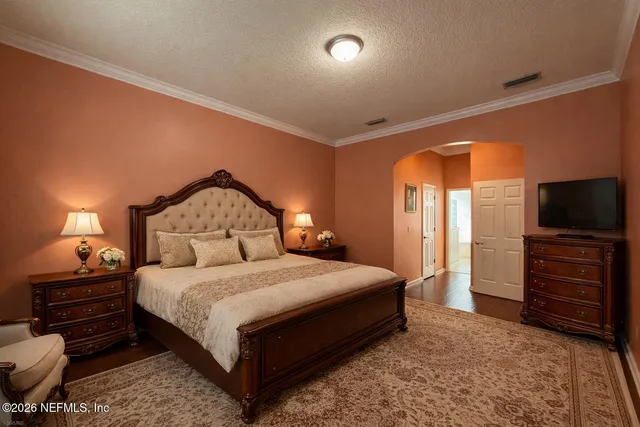 a bedroom with a bed and a television