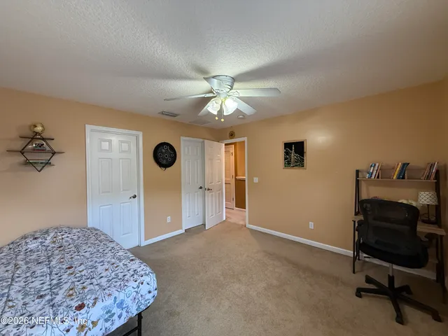 a bedroom with a bed and a chair