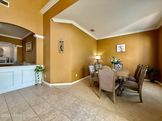 a dining room with a table and chairs