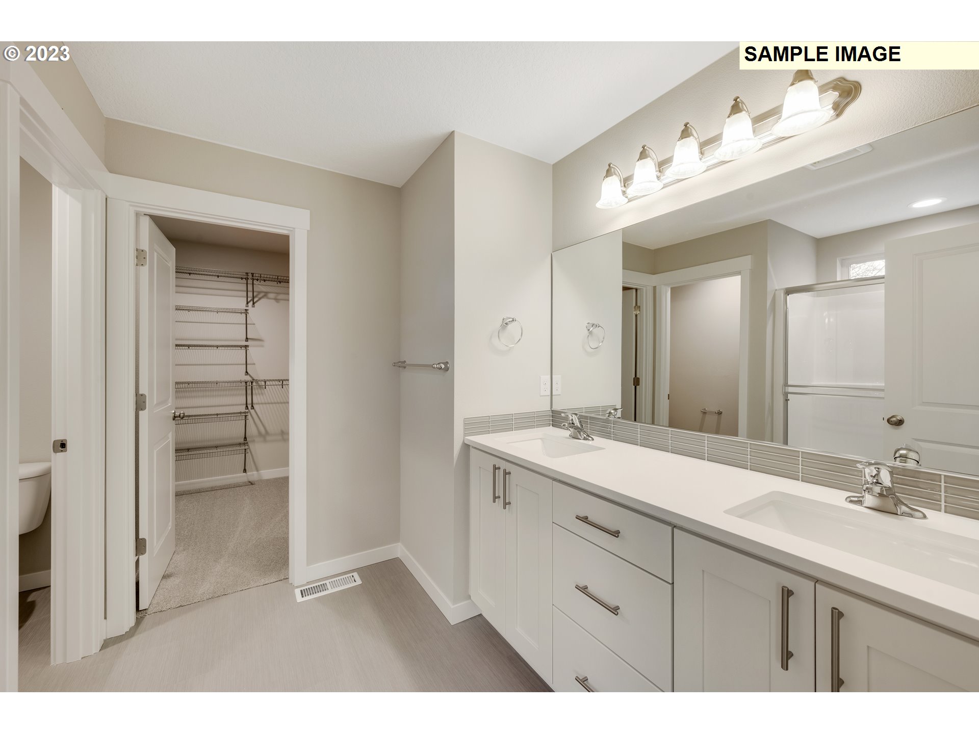 16881 Southeast Mist Layer Loop, Unit 531 Happy Valley, OR 97086 - Photo 11 of 32 a bathroom with a double vanity sink mirror and