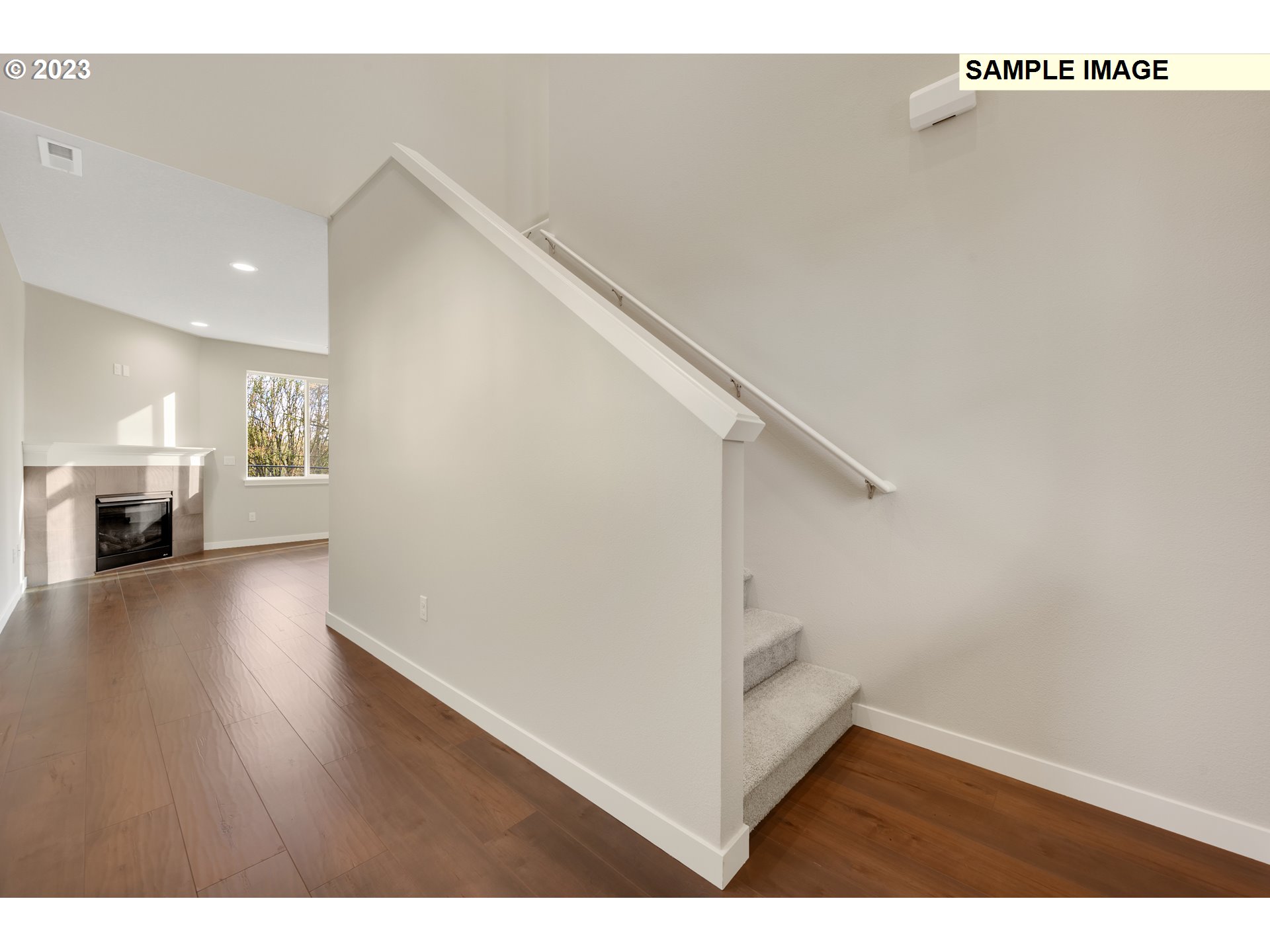 16881 Southeast Mist Layer Loop, Unit 531 Happy Valley, OR 97086 - Photo 19 of 32 a view of a livingroom with wooden floor and staircase