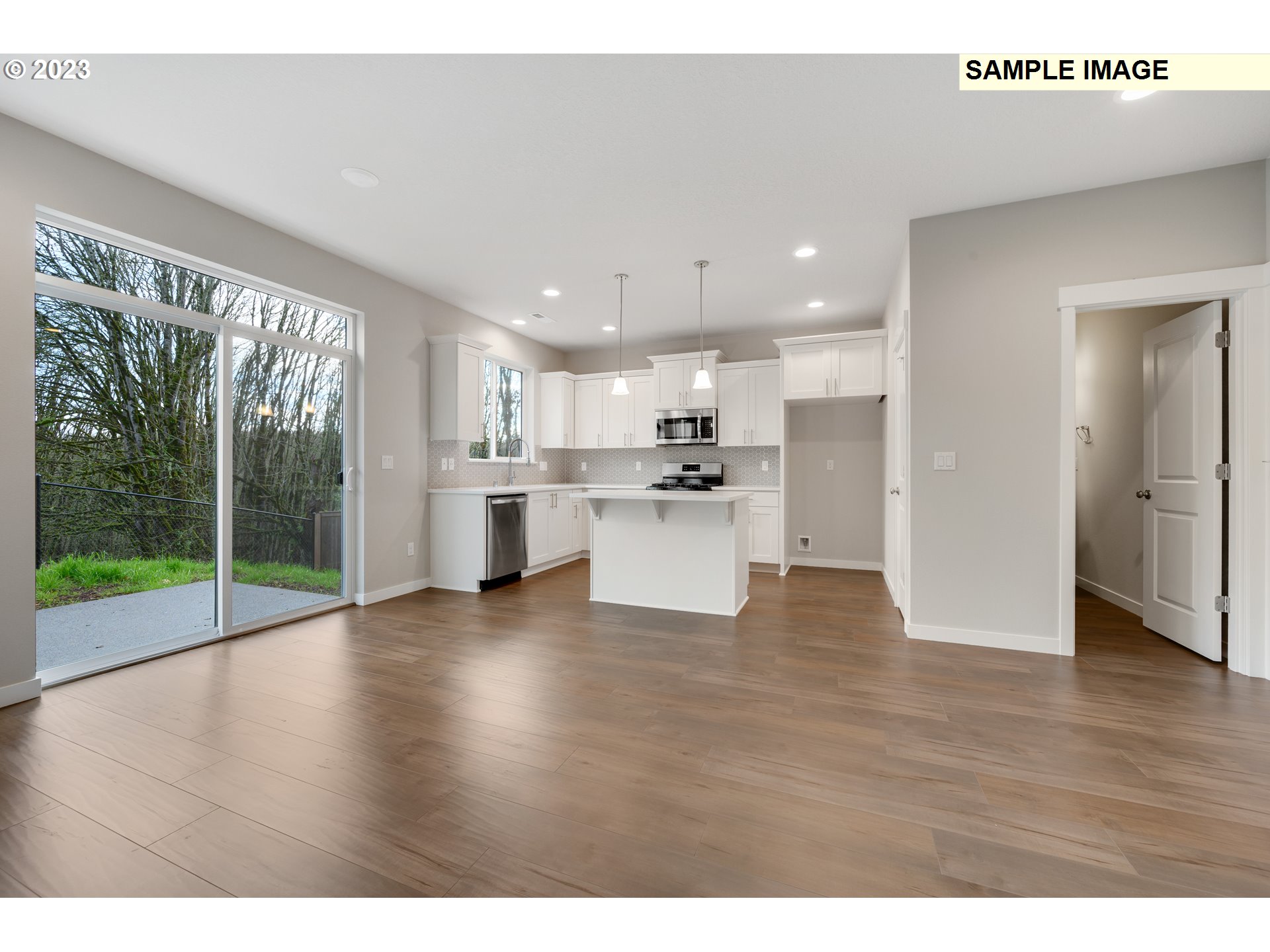 16881 Southeast Mist Layer Loop, Unit 531 Happy Valley, OR 97086 - Photo 24 of 32 a view of kitchen with refrigerator and wooden floor