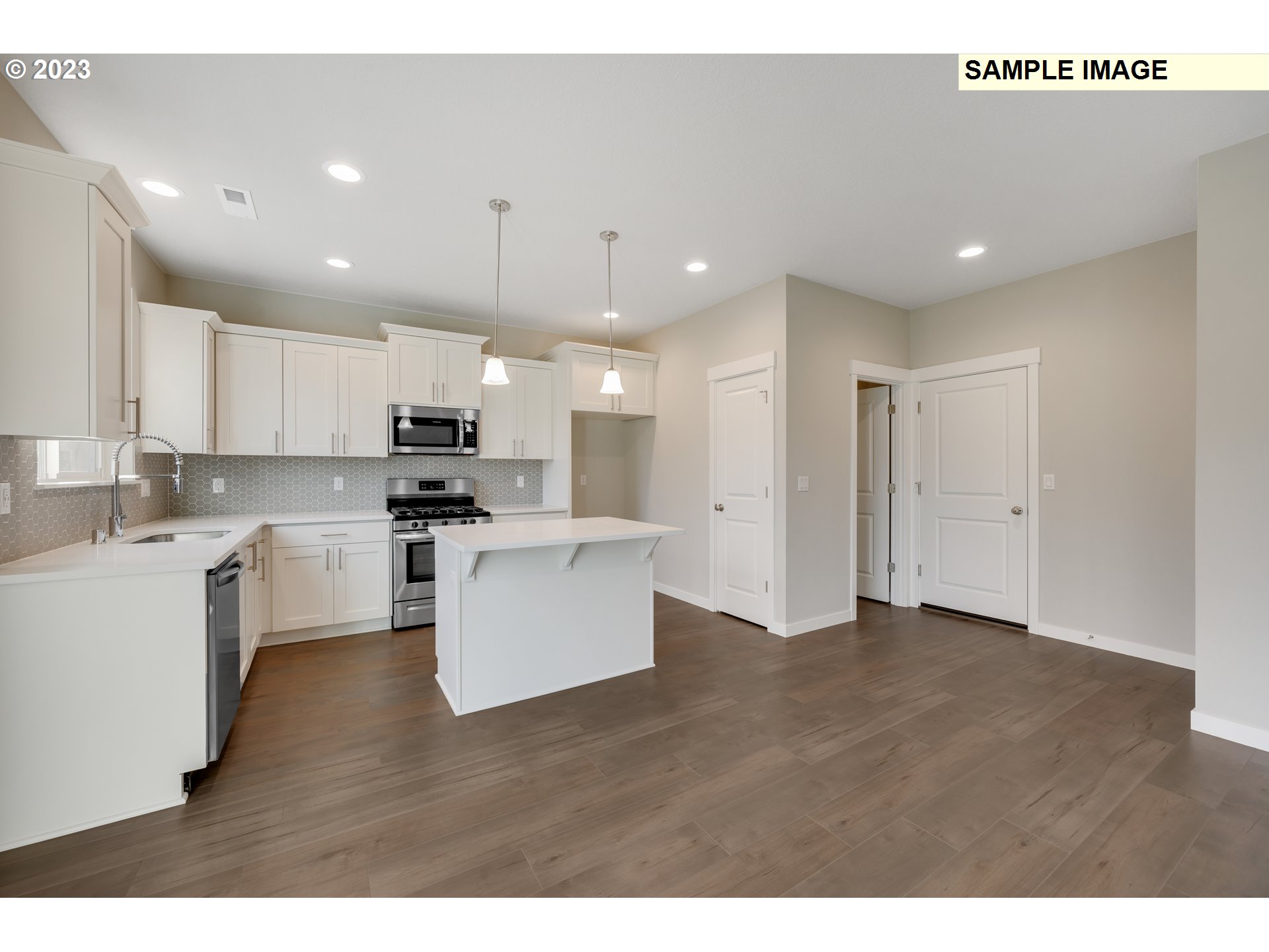 16881 Southeast Mist Layer Loop, Unit 531 Happy Valley, OR 97086 - Photo 25 of 32 a kitchen with white cabinets and stainless steel appliances