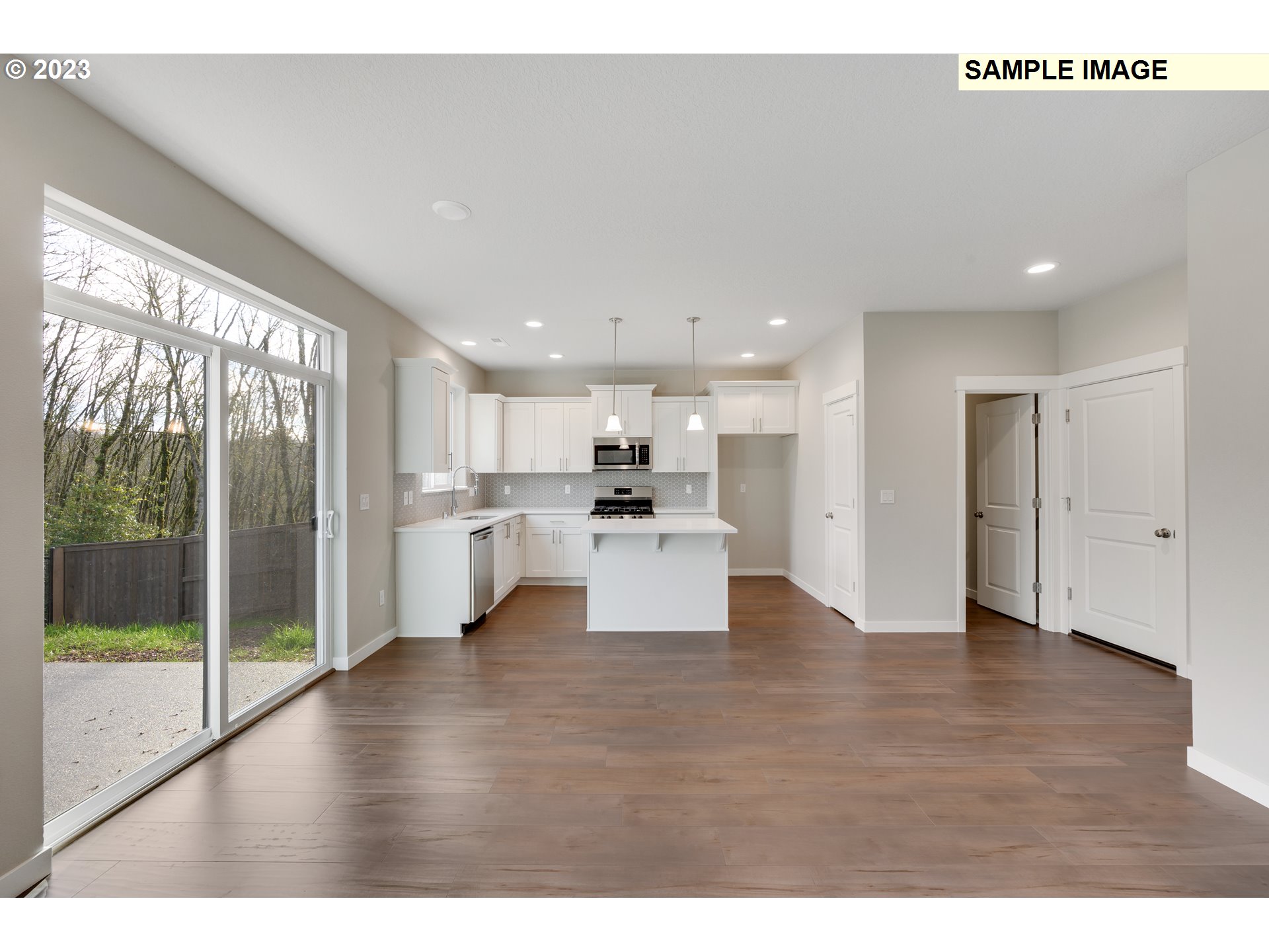 16881 Southeast Mist Layer Loop, Unit 531 Happy Valley, OR 97086 - Photo 28 of 32 a view of a living room and kitchen with furniture wooden floor