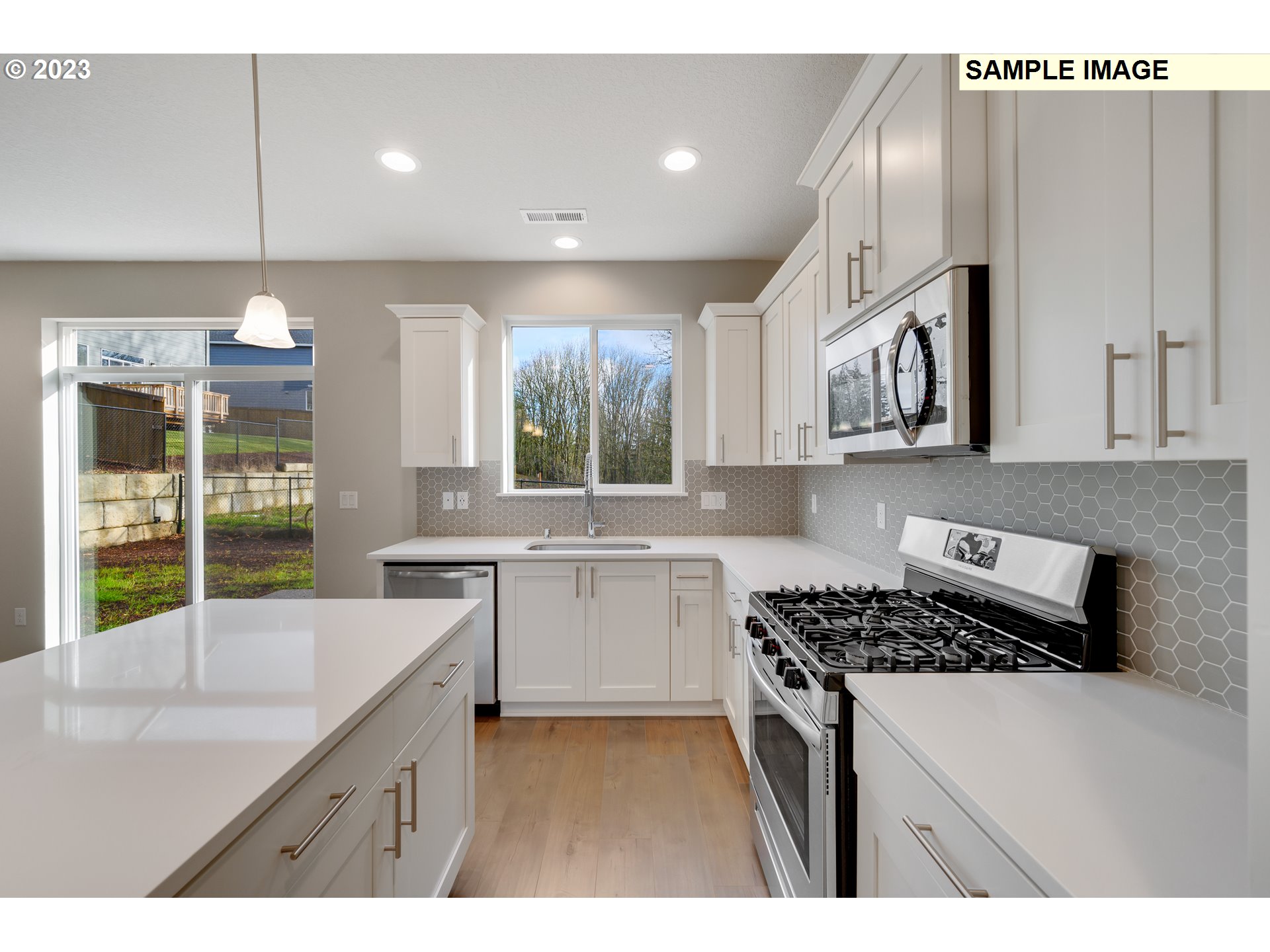 16881 Southeast Mist Layer Loop, Unit 531 Happy Valley, OR 97086 - Photo 4 of 32 a kitchen with a sink stove and cabinets