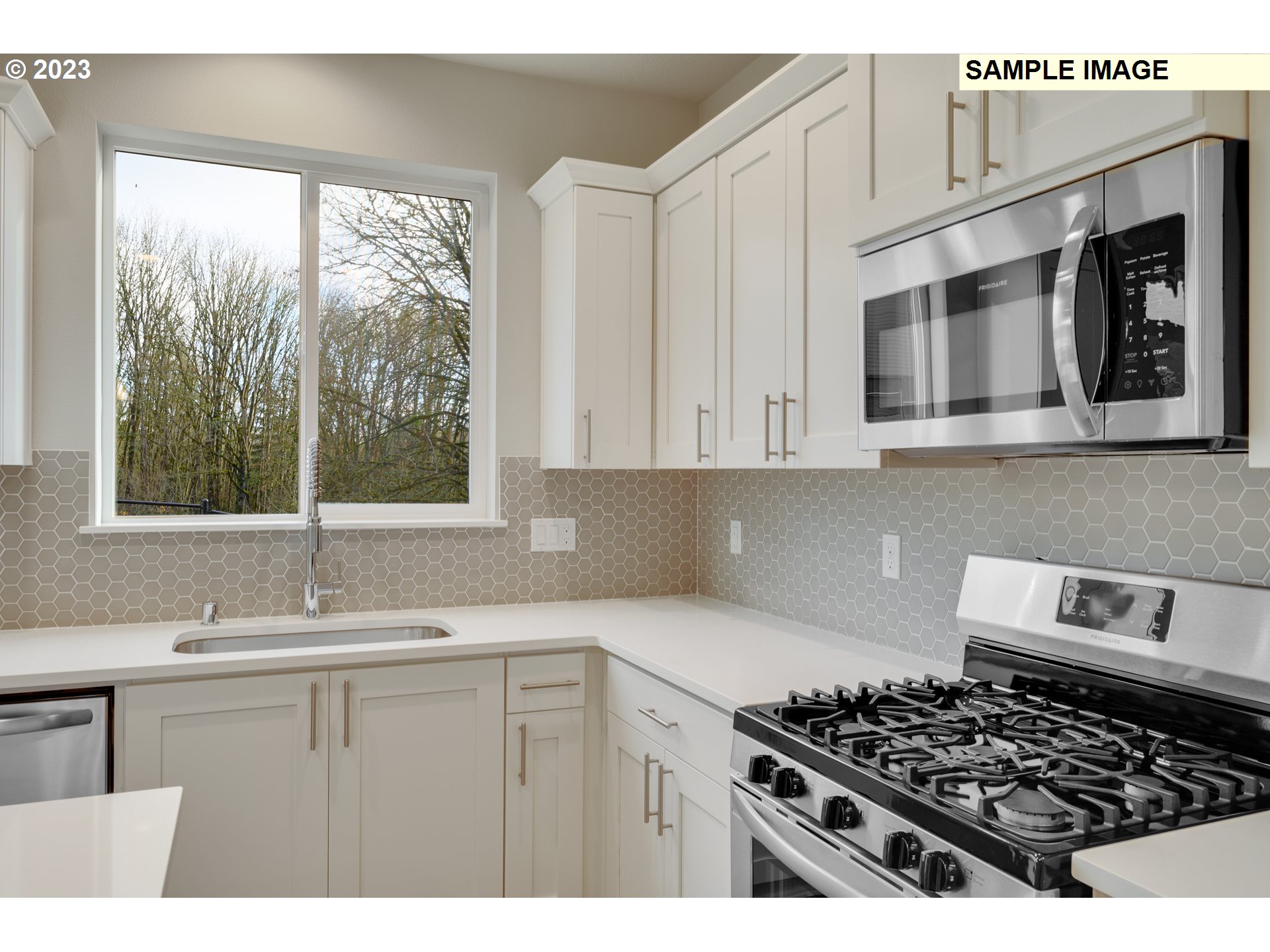16881 Southeast Mist Layer Loop, Unit 531 Happy Valley, OR 97086 - Photo 5 of 32 a kitchen with kitchen island a sink stove top oven and cabinets
