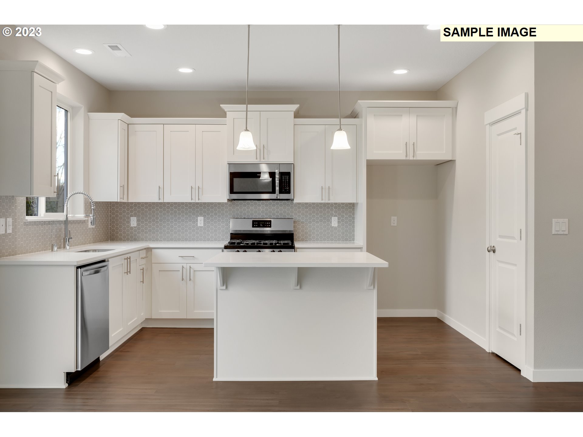 16881 Southeast Mist Layer Loop, Unit 531 Happy Valley, OR 97086 - Photo 6 of 32 a kitchen with kitchen island a sink stainless steel appliances and cabinets