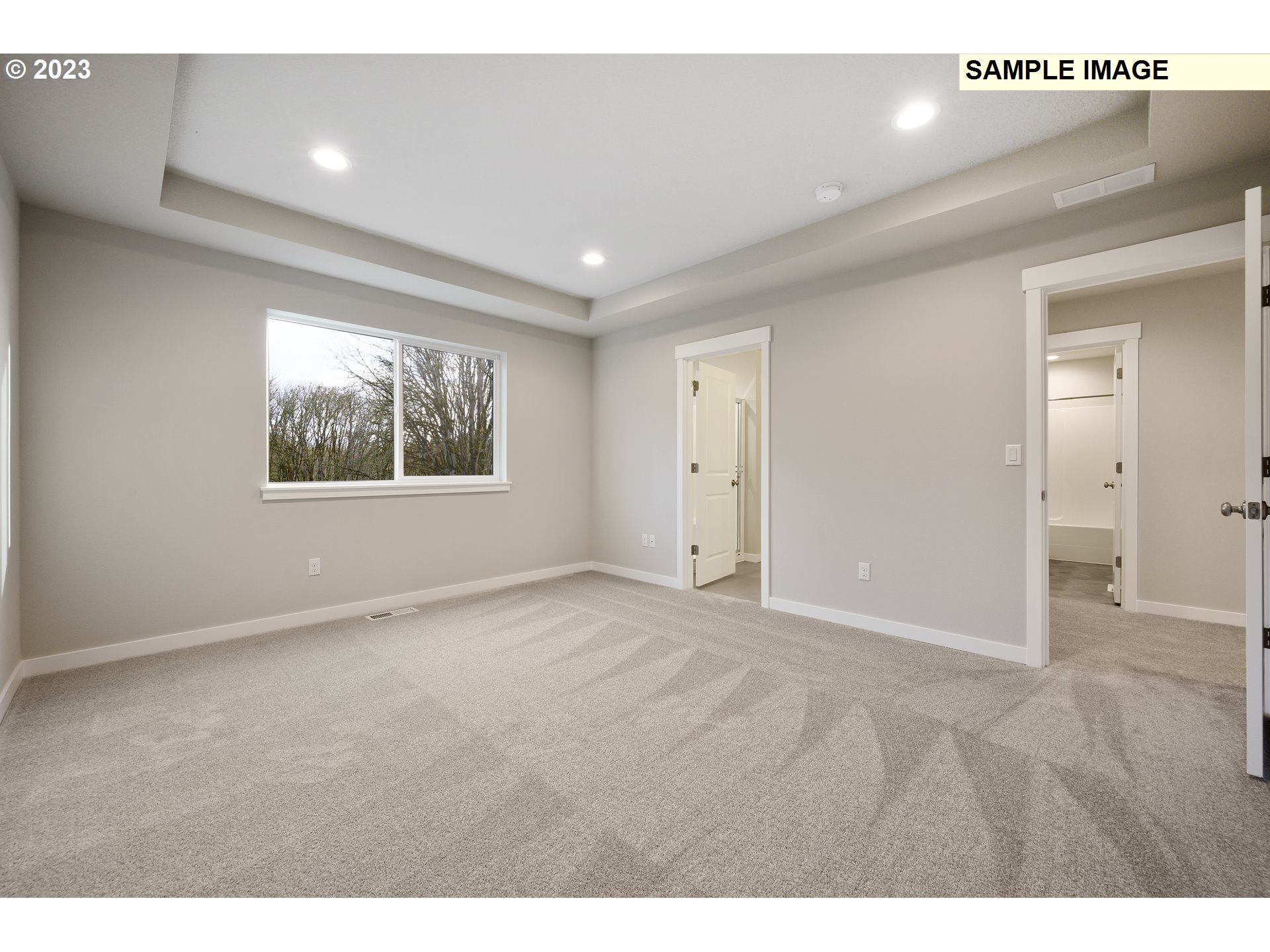 16881 Southeast Mist Layer Loop, Unit 531 Happy Valley, OR 97086 - Photo 9 of 32 a view of an empty room with wooden floor and a window