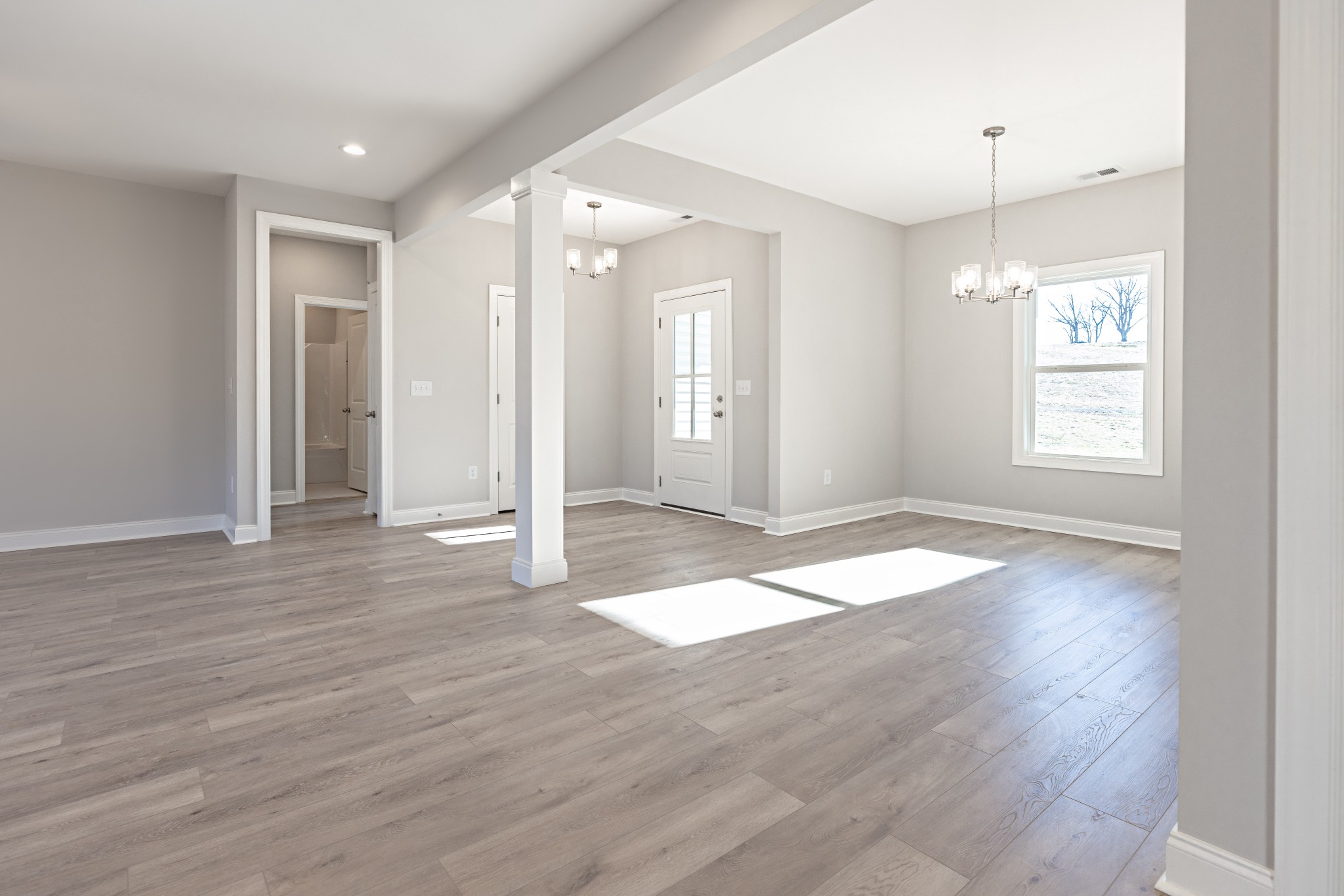 310 Woodruff Road Adams, TN 37010 - Photo 3 of 14 an empty room with wooden floor and windows