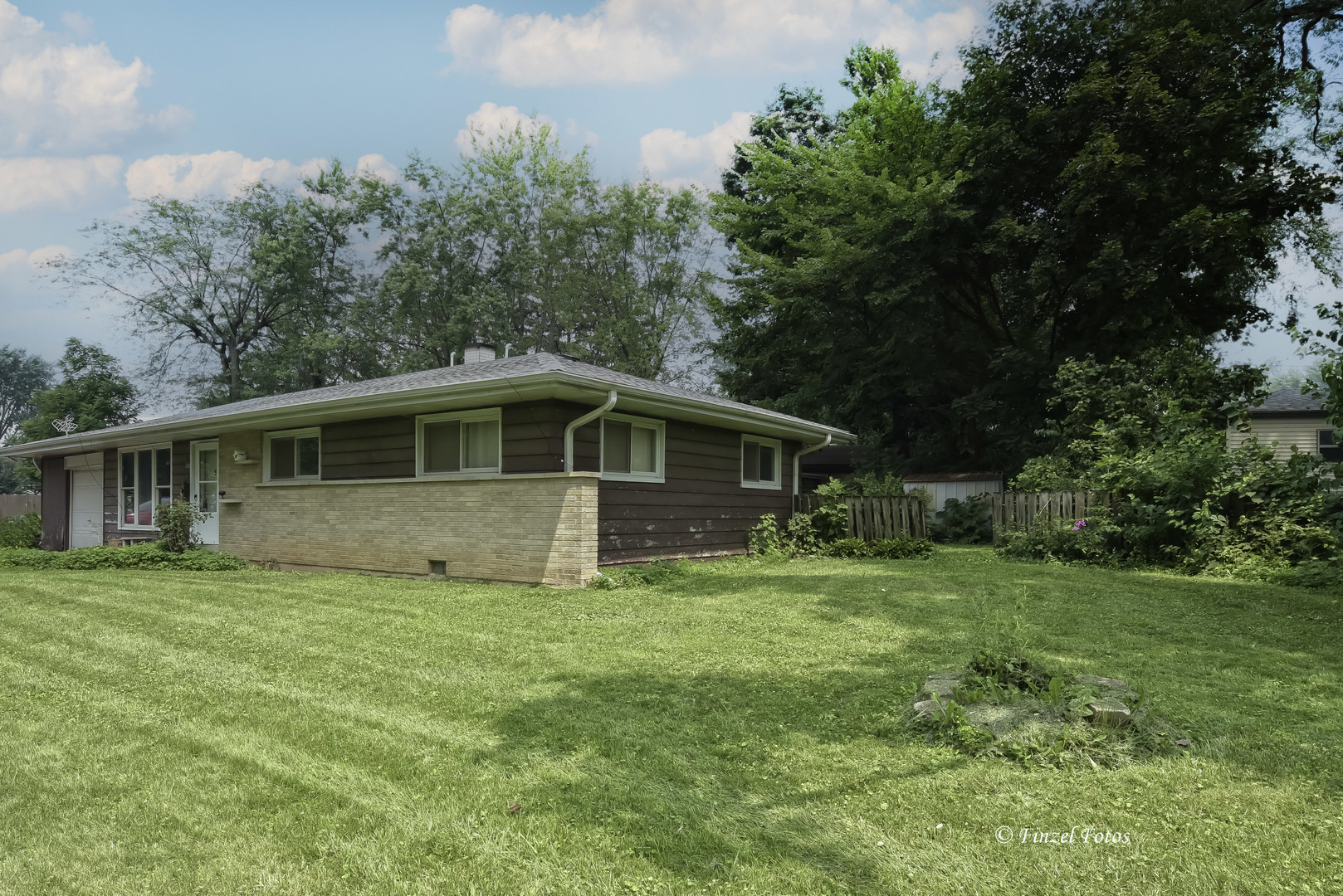557 Willard Avenue Elgin, IL 60120 - Photo 2 of 16 a front view of a house with a garden