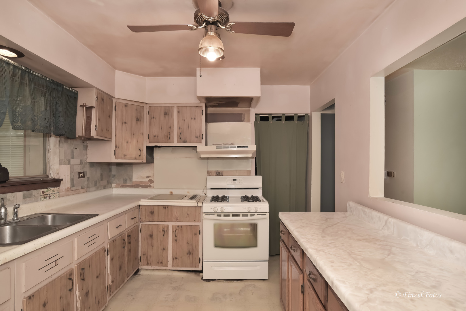 557 Willard Avenue Elgin, IL 60120 - Photo 7 of 16 a kitchen with stainless steel appliances a stove a sink and a refrigerator