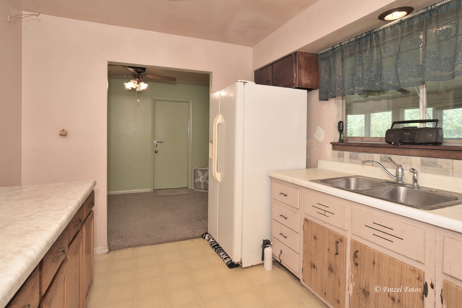 557 Willard Avenue Elgin, IL 60120 - Photo 8 of 16 a kitchen with a sink a refrigerator and cabinets