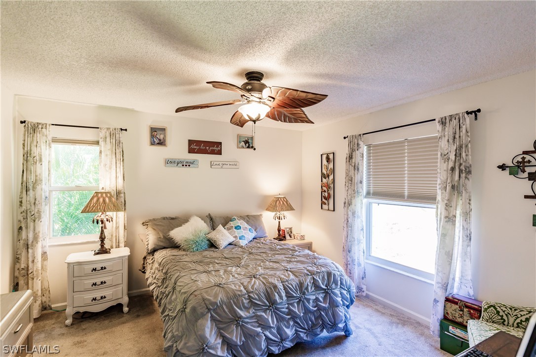 5737 Whitaker Road, Unit C201 Naples, FL 34112 - Photo 15 of 32 a bedroom with a bed and a window