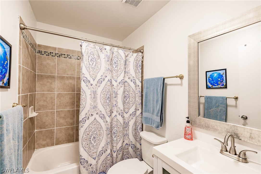 5737 Whitaker Road, Unit C201 Naples, FL 34112 - Photo 21 of 32 a bathroom with a sink toilet and shower